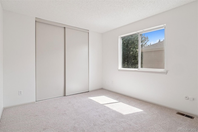 20396 E Berry Pl, Centennial, CO 80015 - unfurnished bedroom featuring carpet flooring, a textured ceiling, and a closet