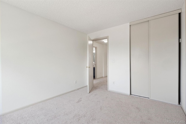 20396 E Berry Pl, Centennial, CO 80015 - unfurnished bedroom with light colored carpet, a closet, and a textured ceiling