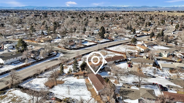 snowy aerial view with a mountain view