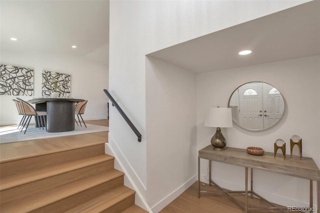 staircase with recessed lighting, baseboards, and wood finished floors