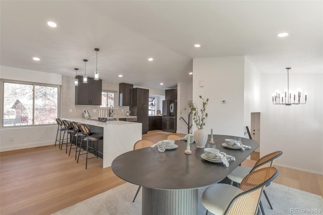 dining room with light wood-style flooring, baseboards, and recessed lighting