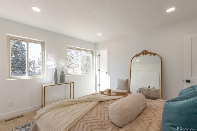 carpeted bedroom featuring baseboards, visible vents, and recessed lighting