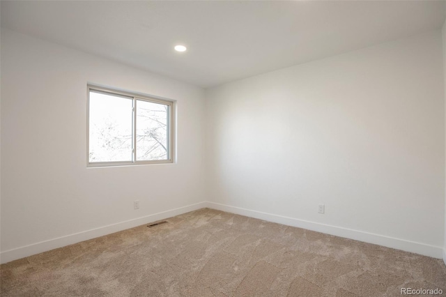 spare room with recessed lighting, baseboards, visible vents, and light colored carpet