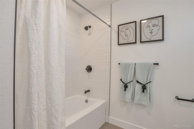 bathroom with baseboards and shower / tub combo with curtain