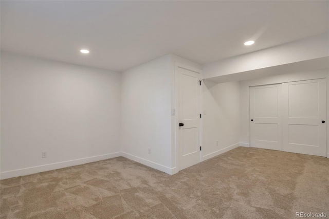 finished below grade area with baseboards, carpet flooring, and recessed lighting