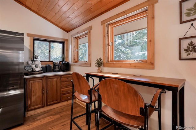 3237 Mill Creek Rd, Dumont, CO 80436 - bar featuring stainless steel refrigerator, lofted ceiling, light wood-style floors, and wooden ceiling