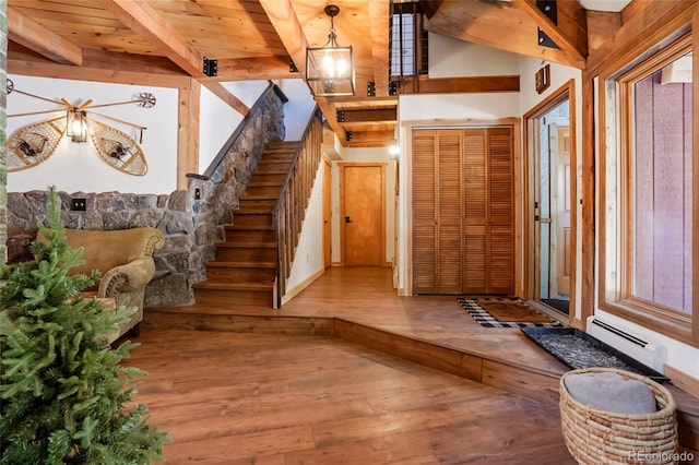 3237 Mill Creek Rd, Dumont, CO 80436 - foyer with wood-type flooring, a baseboard heating unit, stairway, and a wooden ceiling with exposed beams