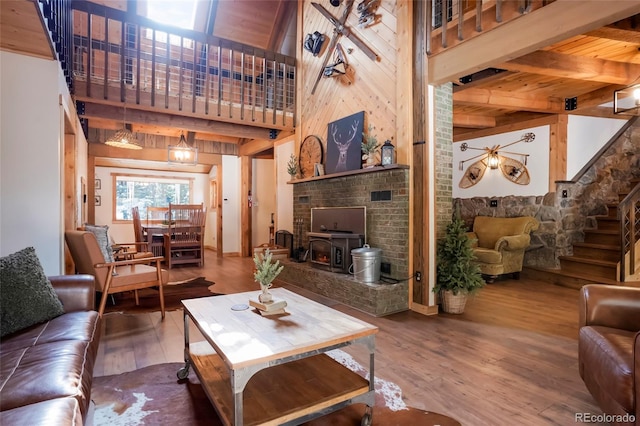 3237 Mill Creek Rd, Dumont, CO 80436 - living room with wood finished floors, stairs, a wooden ceiling with exposed beams, and wooden walls