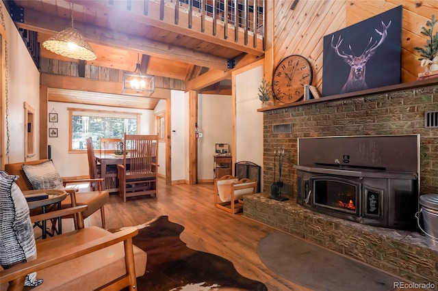 3237 Mill Creek Rd, Dumont, CO 80436 - living area with a brick fireplace, wood finished floors, and a wooden ceiling with exposed beams