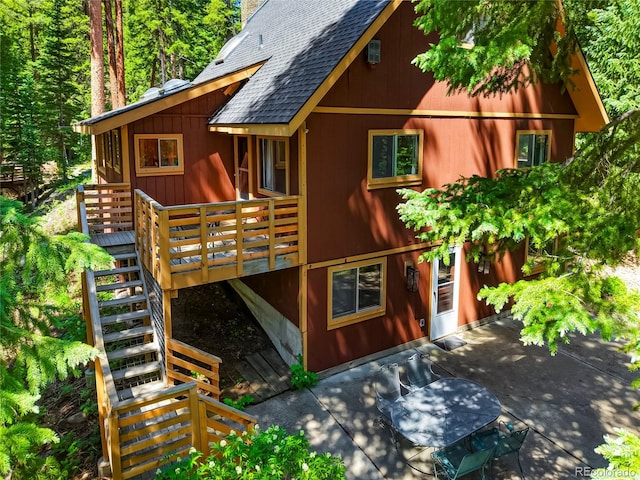 3237 Mill Creek Rd, Dumont, CO 80436 - view of home's exterior featuring roof with shingles, stairs, a wooden deck, and a patio