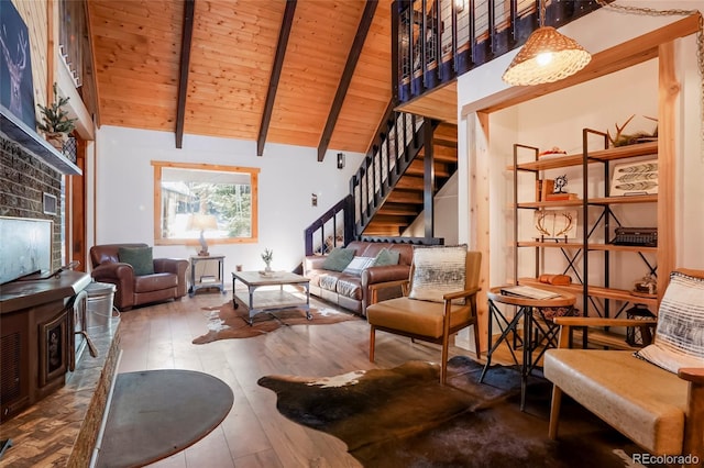 3237 Mill Creek Rd, Dumont, CO 80436 - living area featuring a wooden ceiling with exposed beams, stairway, hardwood / wood-style floors, high vaulted ceiling, and a fireplace