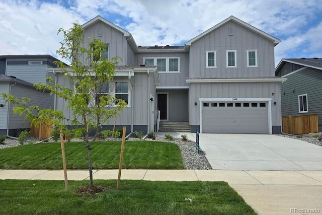 2548 Lupton Ln, Lafayette, CO 80026 - view of front of house with board and batten siding, driveway, and an attached garage