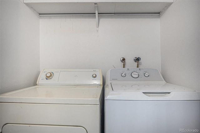clothes washing area featuring washer and dryer