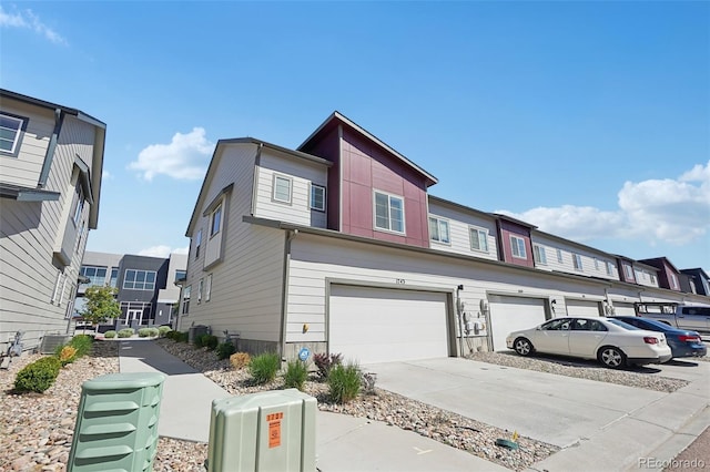 1743 Spring Water Pt, Colorado Springs, CO 80908 - view of front of property with concrete driveway, a garage, and central air condition unit