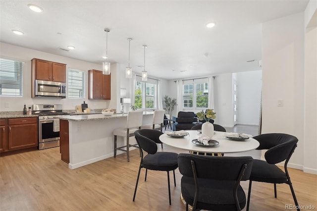 1743 Spring Water Pt, Colorado Springs, CO 80908 - dining space with light wood-style floors, recessed lighting, and baseboards