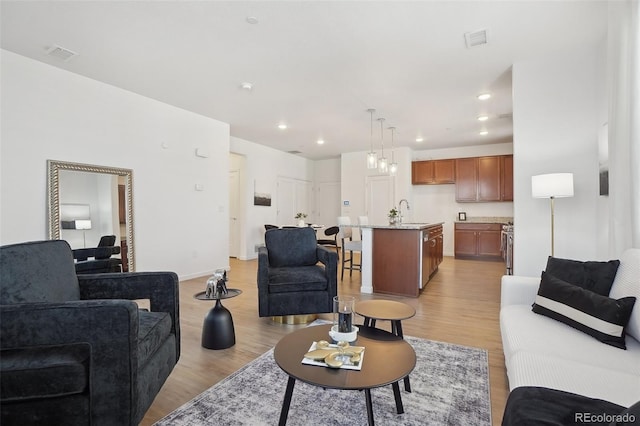 1743 Spring Water Pt, Colorado Springs, CO 80908 - living area featuring light wood-style flooring, recessed lighting, and baseboards
