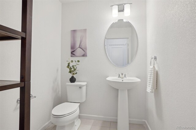 1743 Spring Water Pt, Colorado Springs, CO 80908 - bathroom featuring toilet, tile patterned flooring, baseboards, and a sink