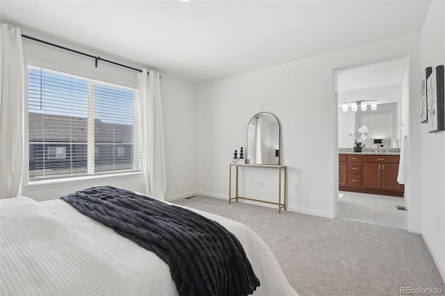 1743 Spring Water Pt, Colorado Springs, CO 80908 - bedroom featuring light carpet, baseboards, and ensuite bath