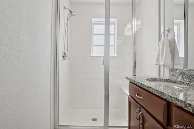 1743 Spring Water Pt, Colorado Springs, CO 80908 - bathroom with a stall shower, vanity, and a textured wall