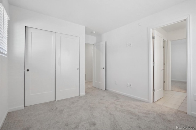 1743 Spring Water Pt, Colorado Springs, CO 80908 - unfurnished bedroom with carpet, a closet, baseboards, and tile patterned floors