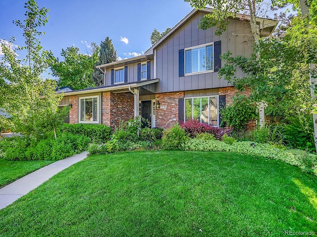 7335 S Milwaukee Way, Centennial, CO 80122 - traditional-style home featuring a front yard, brick siding, and board and batten siding