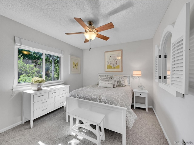 7335 S Milwaukee Way, Centennial, CO 80122 - bedroom with light colored carpet, a textured ceiling, and a ceiling fan
