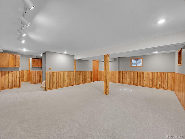 7335 S Milwaukee Way, Centennial, CO 80122 - below grade area featuring wooden walls, wainscoting, and light colored carpet
