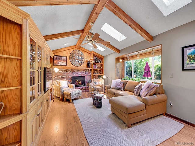 7335 S Milwaukee Way, Centennial, CO 80122 - living area with a skylight, light wood finished floors, a fireplace, and a textured ceiling