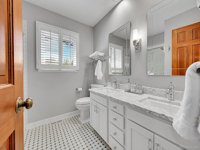 7335 S Milwaukee Way, Centennial, CO 80122 - bathroom featuring healthy amount of natural light, double vanity, and tile patterned floors