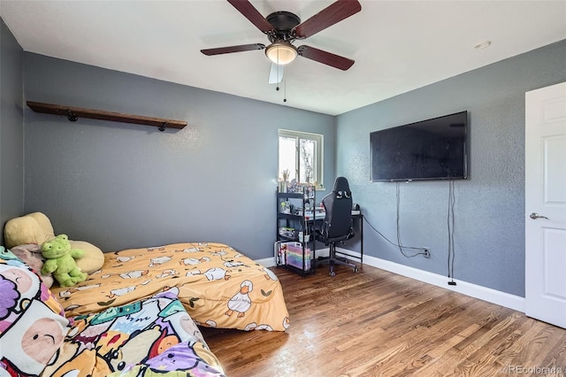 bedroom featuring hardwood / wood-style flooring and ceiling fan