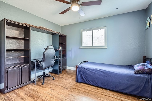 bedroom with ceiling fan and light hardwood / wood-style floors