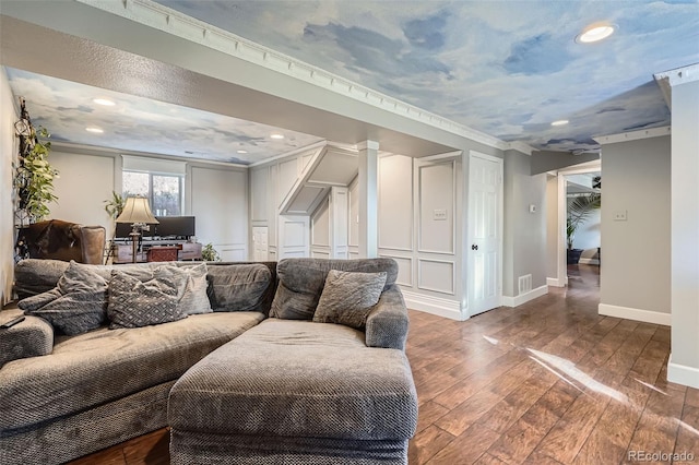 living room with wood-type flooring and crown molding