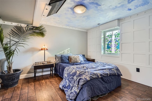 bedroom with dark hardwood / wood-style floors