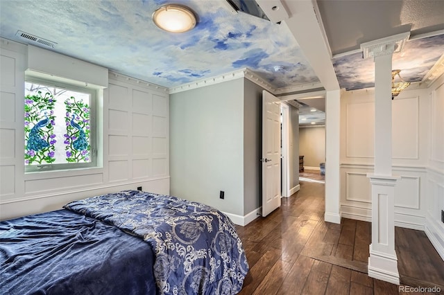 bedroom with dark hardwood / wood-style floors and ornamental molding