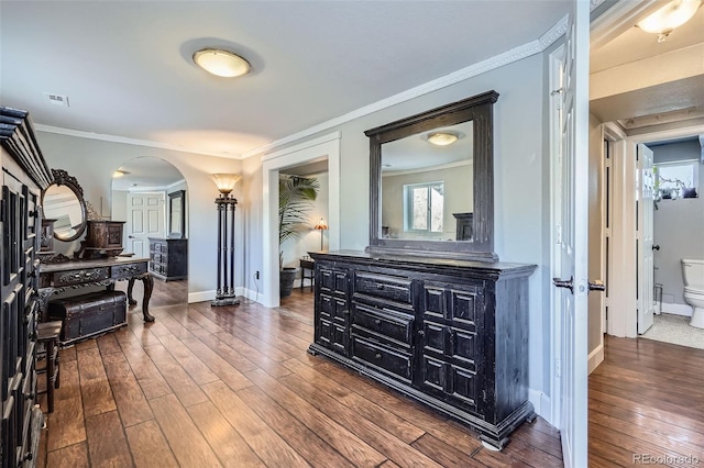 hall with ornamental molding and dark wood-type flooring