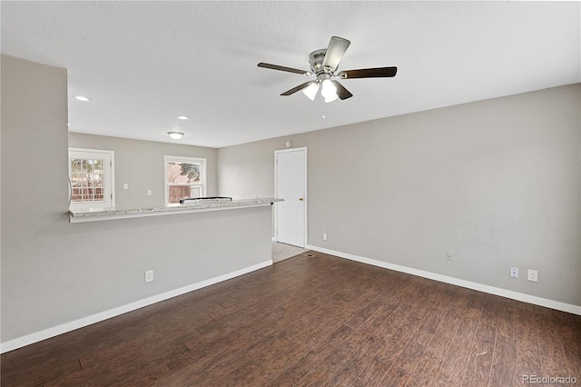 empty room featuring ceiling fan and dark wood-type flooring