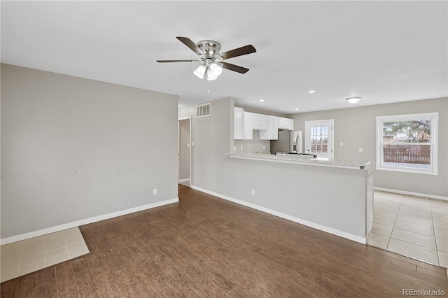 unfurnished living room with hardwood / wood-style floors and ceiling fan