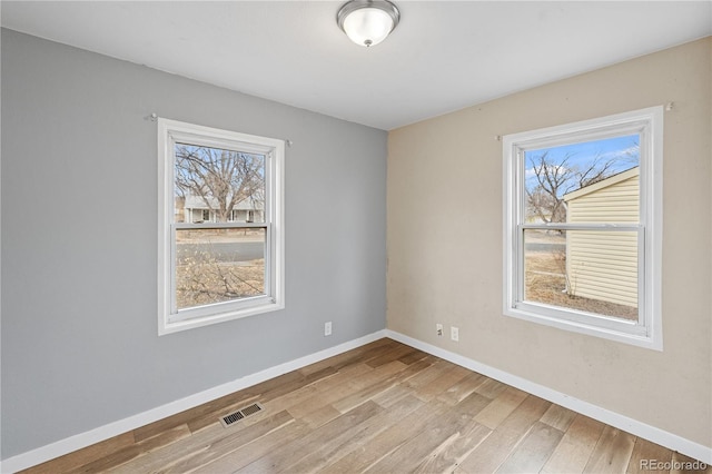 spare room with light hardwood / wood-style flooring