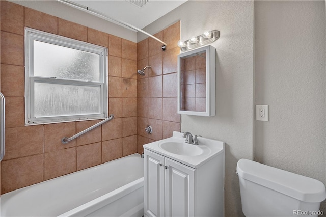 full bathroom with vanity, toilet, and tiled shower / bath