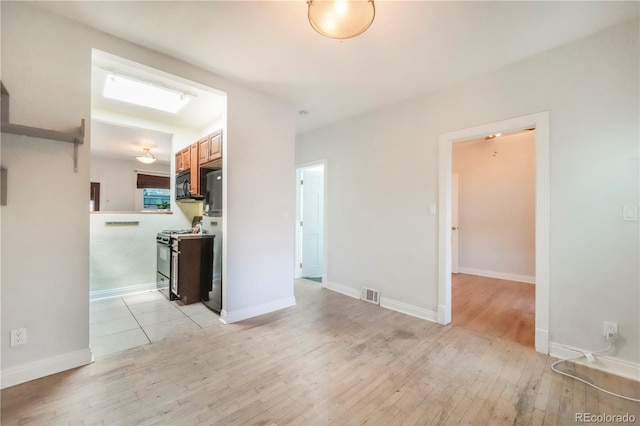 22 E Bayaud Ave, Denver, CO 80209 - unfurnished room with light wood-style flooring and baseboards
