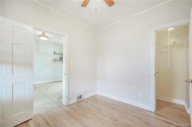 22 E Bayaud Ave, Denver, CO 80209 - unfurnished bedroom with a walk in closet, a closet, light wood-style flooring, and ceiling fan