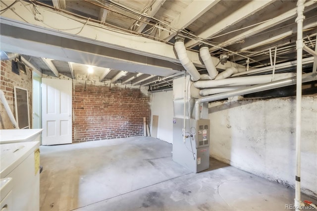 22 E Bayaud Ave, Denver, CO 80209 - unfinished below grade area with independent washer and dryer, brick wall, and heating unit