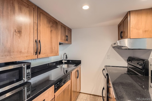 kitchen featuring black range with electric cooktop, stainless steel microwave, under cabinet range hood, a sink, and dark stone countertops