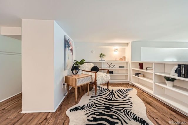 living area featuring baseboards and wood finished floors