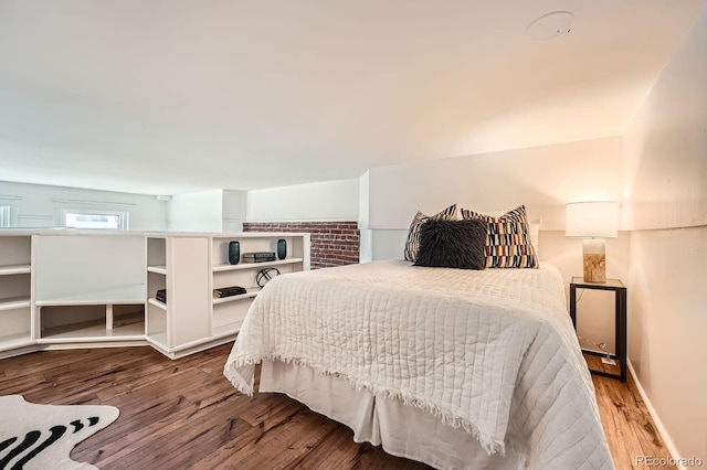 bedroom with baseboards and wood finished floors