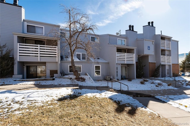 view of snow covered rear of property