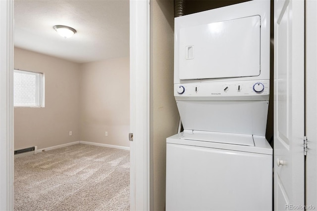 695 Manhattan Dr Unit 5, Boulder, CO 80303 - laundry area featuring stacked washer / dryer, carpet flooring, and a baseboard radiator
