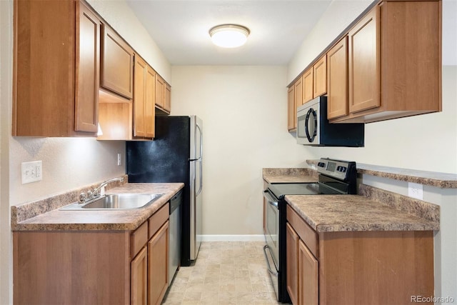 695 Manhattan Dr Unit 5, Boulder, CO 80303 - kitchen featuring stainless steel appliances and brown cabinets
