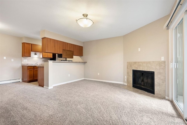 695 Manhattan Dr Unit 5, Boulder, CO 80303 - kitchen with brown cabinets, open floor plan, light colored carpet, a baseboard radiator, and light countertops
