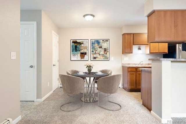 695 Manhattan Dr Unit 5, Boulder, CO 80303 - dining room with a baseboard radiator, light carpet, and baseboard heating